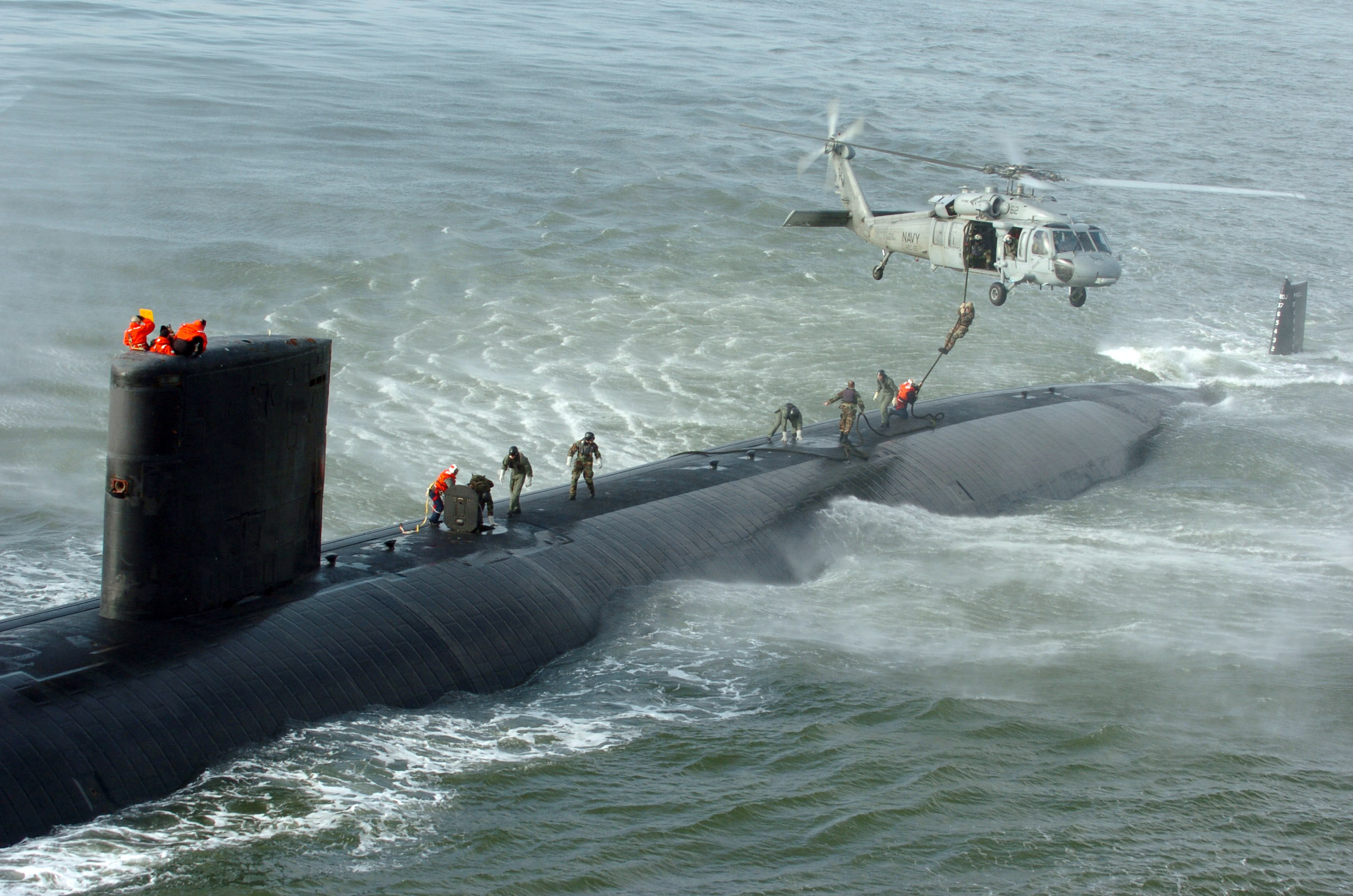 060117-N-3541A-002 Atlantic Coast (Jan. 17, 2005) Ð A SEAL delivery vehicle team (SDV) perform a fast-roping exercise from a MH-60S Seahawk helicopter to the topside of Los Angeles-class submarine USS Toledo (SSN 769). The mission of the SDV teams includes clandestine insertion of SEALs, ordnance delivery, reconnaissance, and locating and the recovery of objects. U.S. Navy photo by Journalist 3rd Class Davis J. Anderson (RELEASED)